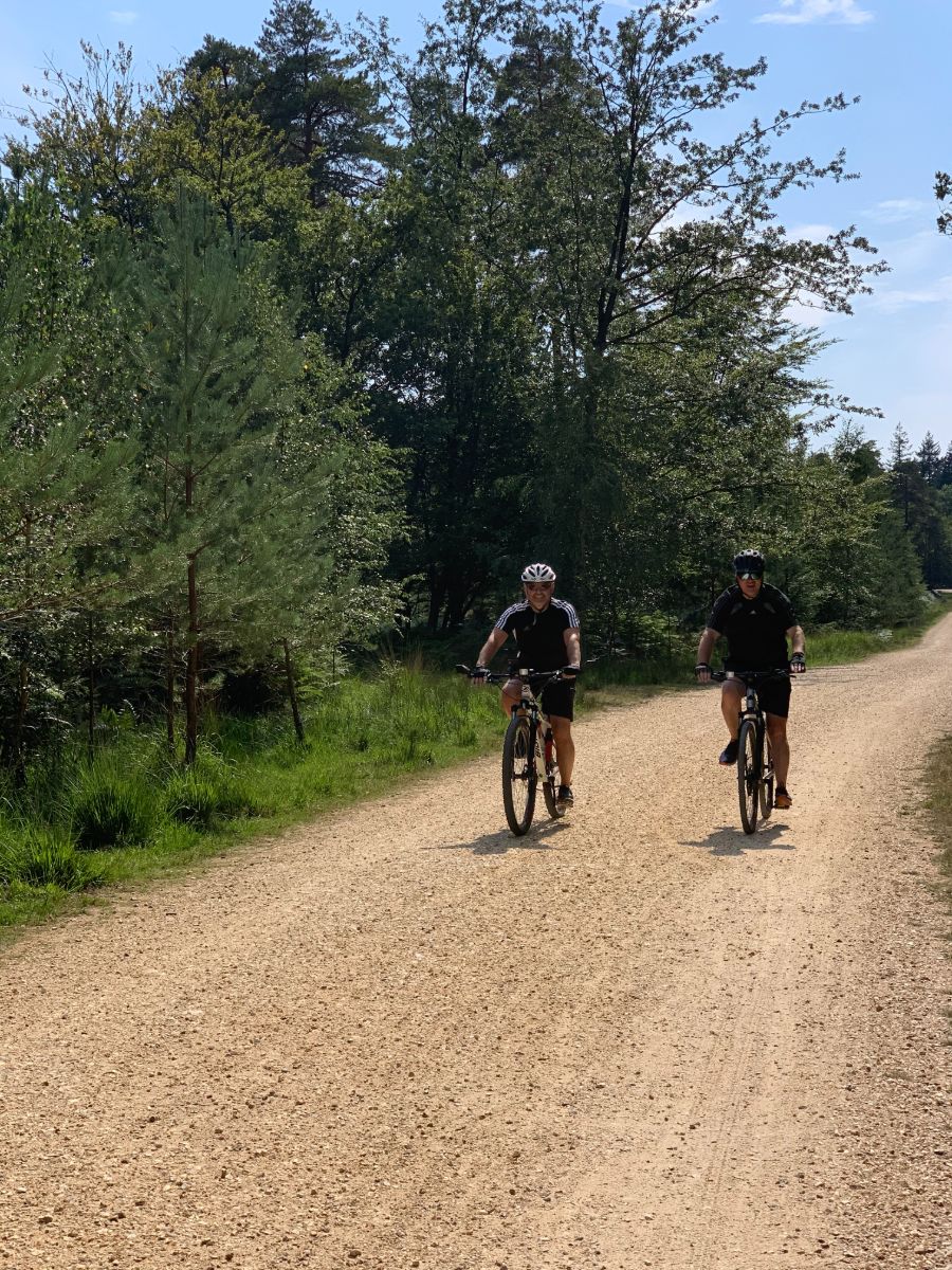 two people cycling through forest